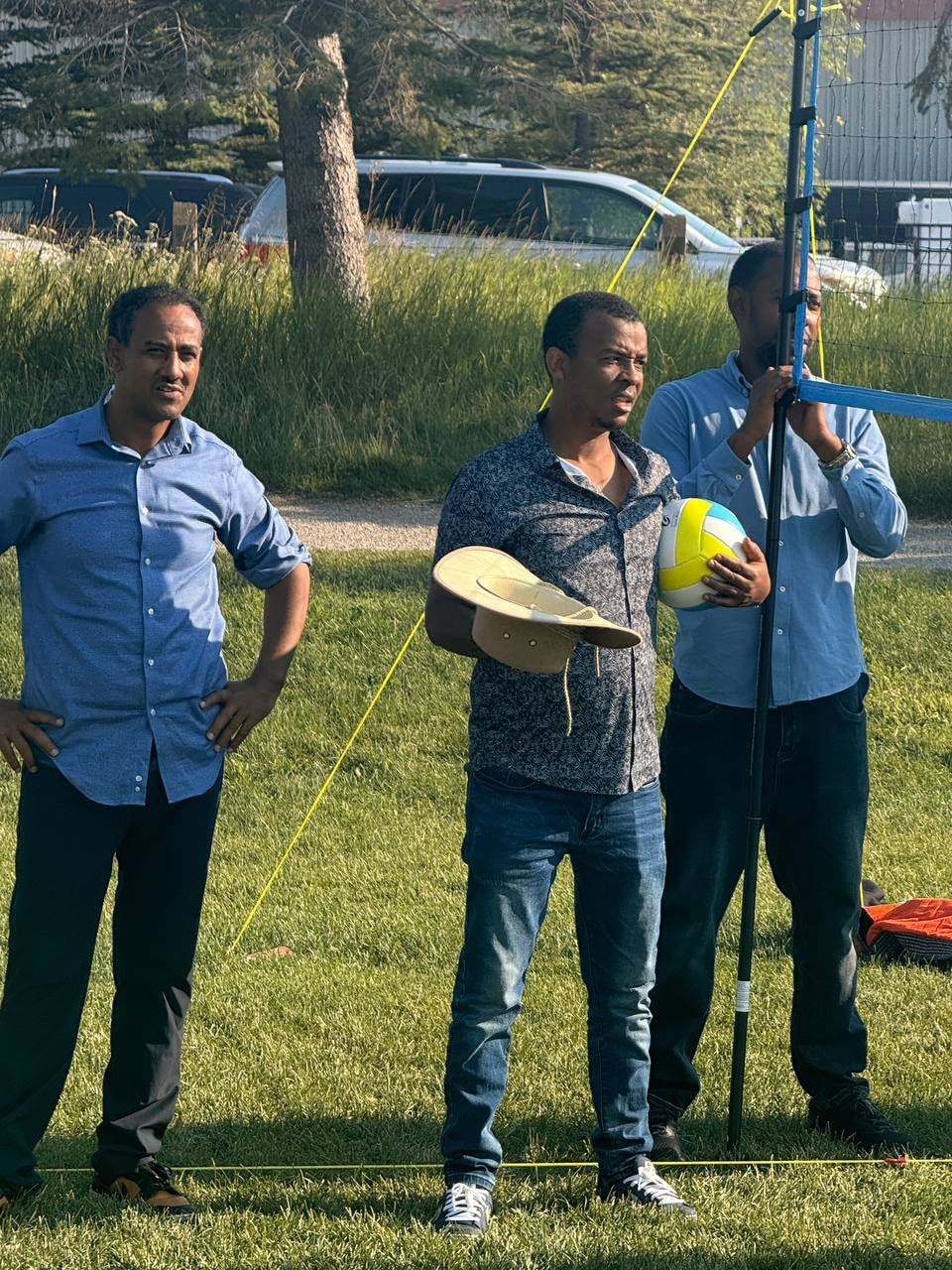 Three men launching a kite outdoors