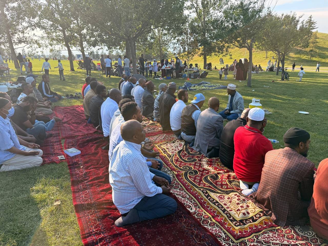 Community gathering in prayer at a park